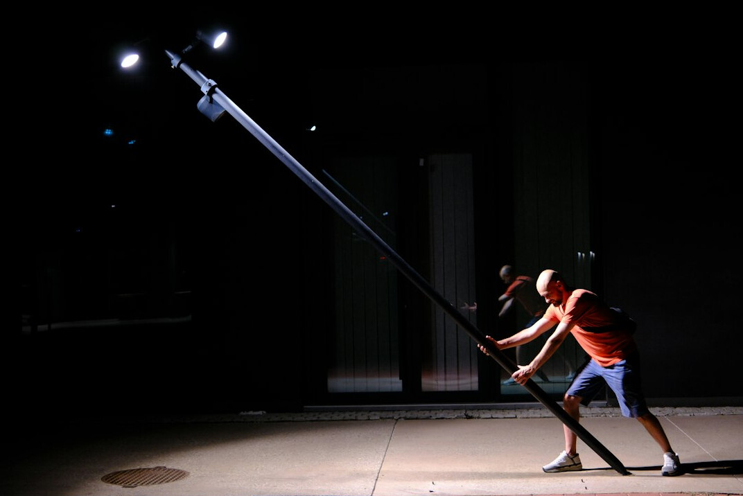 Film set with lighting rigs and a boom microphone