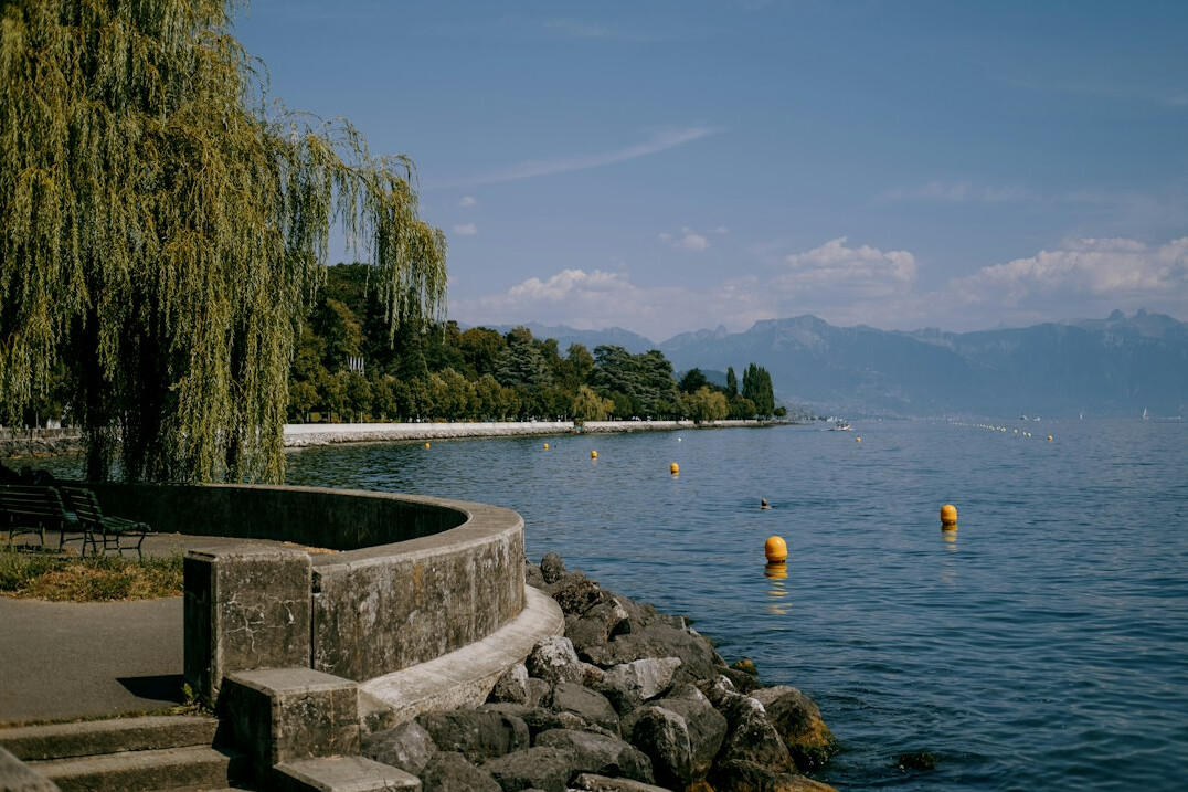 Lake Geneva shoreline with mountains in the background